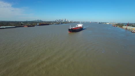 Remarkable-aerial-shot-over-a-massive-tanker-ship-traveling-on-the-Mississippi-River-outside-New-Orleans-Louisiana
