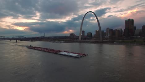 Beautiful-aerial-over-a-Mississippi-river-barge-with-the-St-Louis-Missouri-skyline-background