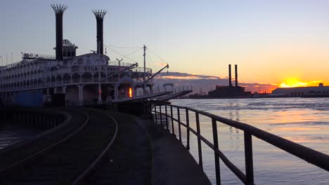 Beautiful-shot-of-a-large-Mississippi-paddlewheel-riverboat-docked-at-sunset-near-New-Orleans