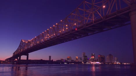 Beautiful-shot-of-the-Crescent-City-Bridge-at-night-with-New-Orleans-Louisiana-in-the-background