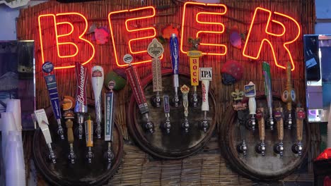 A-neon-sign-at-a-tiki-bar-advertises-beer