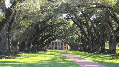 A-wide-shot-of-a-beautiful-gracious-Southern-mansion-on-an-estate-amongst-oak-trees