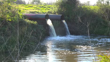 Contaminated-water-is-dumped-into-a-waterway-through-industrial-pipes-1