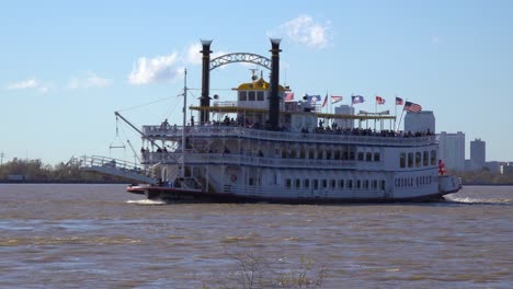 A-paddlewheel-steamboat-passes-on-the-Mississippi-River-with-new-Orleans-in-the-background
