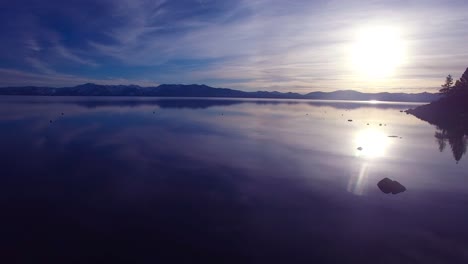 A-beautiful-vista-aérea-shot-over-Lake-Tahoe-with-the-shoreline-in-silhouette-1