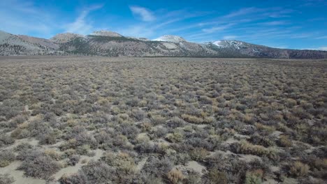 Beautiful-vista-aérea-shot-over-desert-sagebrush-reveals-the-Mono-volcano-cones-in-the-Eastern-Sierra-Nevada-mountains