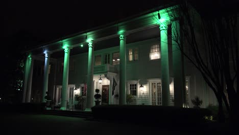 The-exterior-of-an-elegant-southern-colonial-mansion-at-night