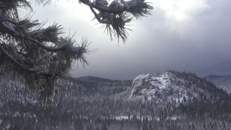 Clouds-and-fog-move-over-a-beautiful-snow-scene-in-winter-in-the-high-Sierra-Nevada-mountains