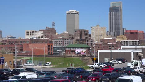 Establishing-shot-of-downtown-Omaha-Nebraska-with-[parking-lot-foreground