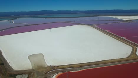 Aerial-footage-over-the-remarkable-red-and-white-salt-flats-in-the-Fremont-California-bay-area-1