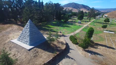 An-vista-aérea-shot-over-a-large-stone-pyramid-in-a-cemetery-near-San-Luis-Obispo-California-1