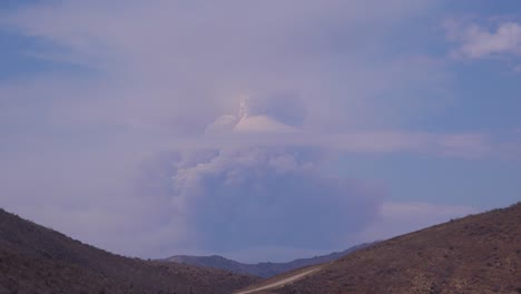 A-timelapse-shot-of-smoke-rising-in-a-huge-mushroom-cloud-as-a-wildfire-rages-1