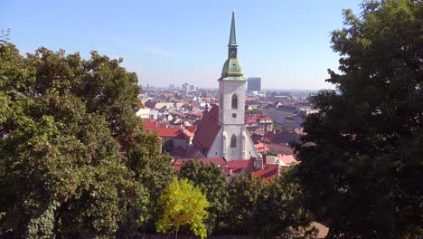 Beautiful-establishing-shot-of-downtown-Bratislava-Slovakia-with-church-foreground