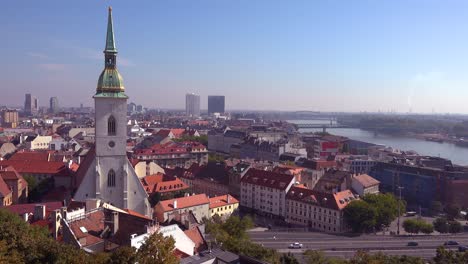 Beautiful-establishing-shot-of-downtown-Bratislava-Slovakia-with-church-foreground-1