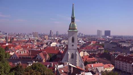 Beautiful-establishing-shot-of-downtown-Bratislava-Slovakia-with-church-foreground-2