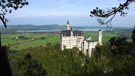 A-classic-view-through-the-trees-of-Neuschwanstein-Mad-Ludwigs-castle-in-Bavaria-Germany