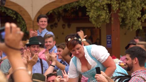 A-German-woman-drinks-a-full-stein-of-beer-and-receives-an-ovation-at-Okroberfest-in-Germany