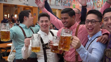 Happy-people-drink-toast-and-celebrate-at-Oktoberfest-Germany