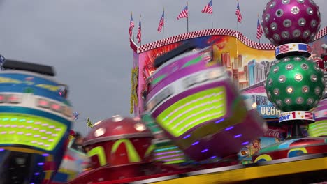 A-tilt-a-whirl-style-ride-and-an-amusement-park-spins-in-circles-1