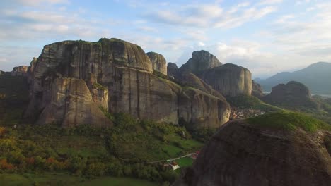 Beautiful-aerial-in-golden-light-over-the-rock-formations-of-Meteora-Greece
