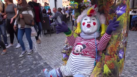 A-strange-street-performing-clown-acts-like-a-baby