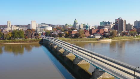 Good-drone-aerial-establishing-shot-of-Pennsylvania-capital-building-in-Harrisburg-with-Susquehanna-River-bridge-foreground
