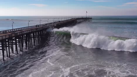 Aerial-over-huge-waves-rolling-in-over-a-California-pier-in-Ventura-California-during-a-big-winter-storm-suggests-global-warming-and-sea-level-rise-or-tsunami-6