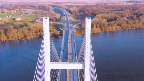 A-drone-aerial-of-cars-and-trucks-crossing-a-bridge-over-the-Mississippi-River-at-Burlington-Iowa-suggesting-infrastructure-shipping-trucking-or-transportation