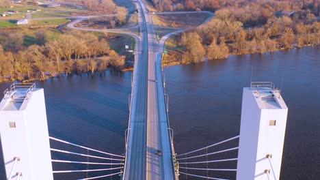 A-drone-aerial-of-cars-and-trucks-crossing-a-bridge-over-the-Mississippi-River-at-Burlington-Iowa-suggesting-infrastructure-shipping-trucking-or-transportation-1
