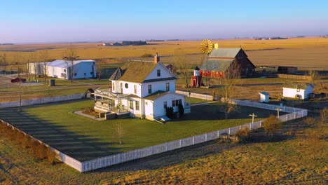 A-drone-aerial-establishing-shot-over-a-classic-beautiful-farmhouse-farm-and-barns-in-rural-midwest-America-York-Nebraska