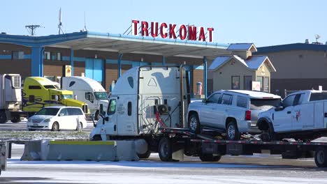 Trucks-are-stopped-in-the-snow-at-a-Truckomat-washing-station-and-truckstop