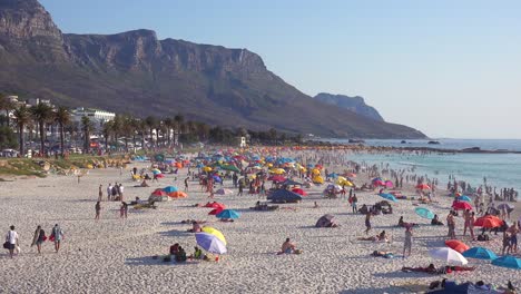 A-crowded-and-busy-holiday-beach-scene-at-Camps-Bay-Cape-Town-South-Africa-with-Twelve-Apostles-mountains-background-2