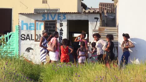 Patrons-gather-at-a-beauty-salon-and-barber-shot-in-the-Gugulethu-township-of-South-Africa