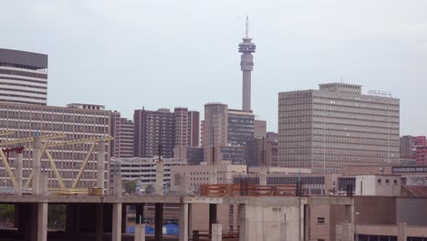 Establishing-shot-of-downtown-business-district-skyline-of-Johannesburg-South-Africa-with-tower-and-street-traffic