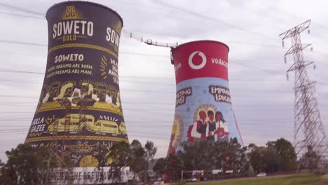 POV-from-a-passing-car-of-painted-cooling-towers-in-Soweto-South-Africa