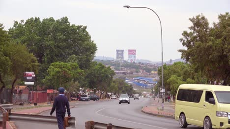 Establishing-shot-of-painted-cooling-towers-in-distance-of-Soweto-township-South-Africa