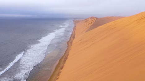 Astonishing-aerial-shot-over-the-vast-sand-dunes-of-the-Namib-Desert-along-the-Skeleton-Coast-of-Namibia-ends-on-safari-van