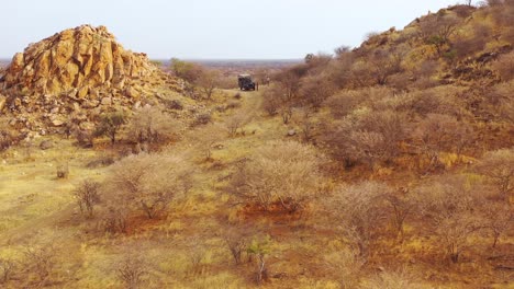 Aerial-of-tourists-enjoying-a-moment-on-a-safari-jeep-at-the-vast-and-beautiful-Erindi-Game-Preserve-Namibia-1