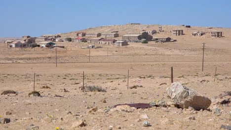 Exterior-establishing-shot-of-abandoned-buildings-in-the-Namib-desert-at-the-ghost-town-of-Kolmanskop-Namibia-1