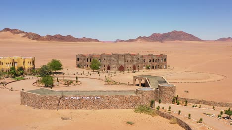 Aerial-of-the-spectacular-Le-Mirage-Resort-lodge-hotel-castle-and-spa-in-the-Sossusvlei-region-of-Namib-Desert-Namibia-