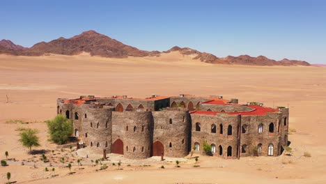 Aerial-of-the-spectacular-Le-Mirage-Resort-lodge-hotel-castle-and-spa-in-the-Sossusvlei-region-of-Namib-Desert-Namibia--1