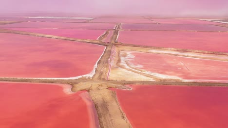 Beautiful-aerial-over-bright-red-and-pink-salt-pan-farms-near-Walvis-Bay-Namibia-2