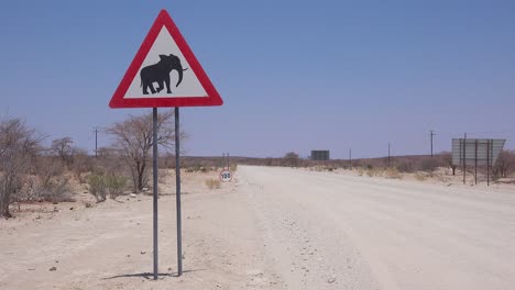 A-beware-of-elephant-crossing-sign-warns-visitors-on-a-dirt-road-in-Namibia-Africa