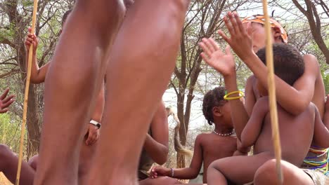 African-San-bushmen-women-niños-and-tribal-natives-sit-in-a-circle-chanting-singing-and-clapping-in-a-small-village-in-Namibia-8