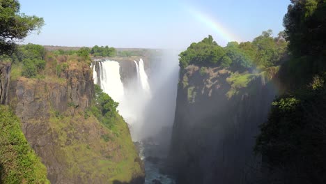 Beautiful-establishing-shot-with-rainbow-of-Victoria-Falls-from-the-Zimbabwe-side-of-the-African-waterfall