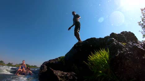 A-man-dives-into-Devil's-Pool-the-edge-of-Victoria-Falls-Zambia-close-to-the-edge-of-the-waterfalls