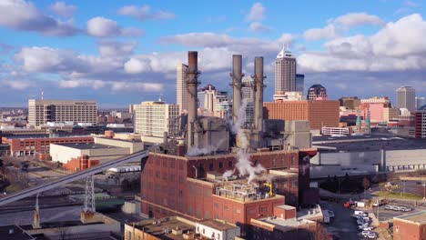 Nice-drone-aerial-of-downtown-Indianapolis-Indiana-with-industrial-factory-in-foreground-1