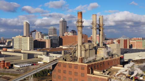 Nice-drone-aerial-of-downtown-Indianapolis-Indiana-with-industrial-factory-in-foreground-3