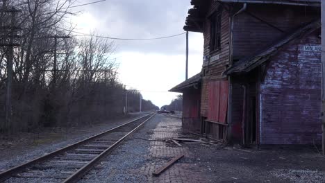An-old-abandoned-railways-station-platform-and-empty-rail-line-railroad-track-in-distance-suggests-lonely-places