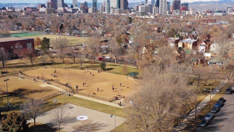 Great-aerial-over-a-dog-park-and-pet-owners-to-reveal-the-downtown-skyline-of-Denver-Colorado-1